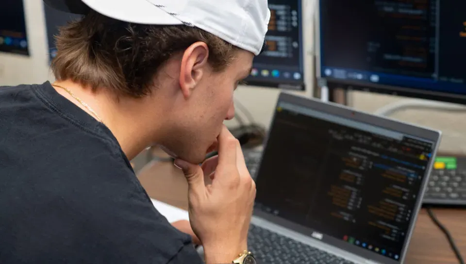 A student works with data on a laptop